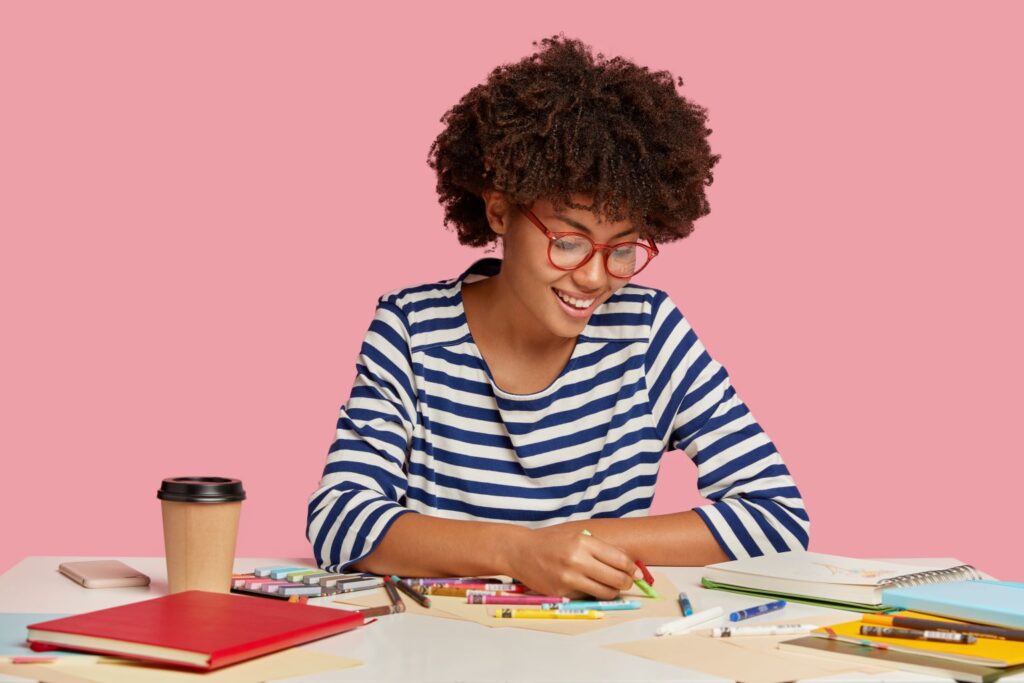 indoor-shot-pleased-artist-holds-crayon