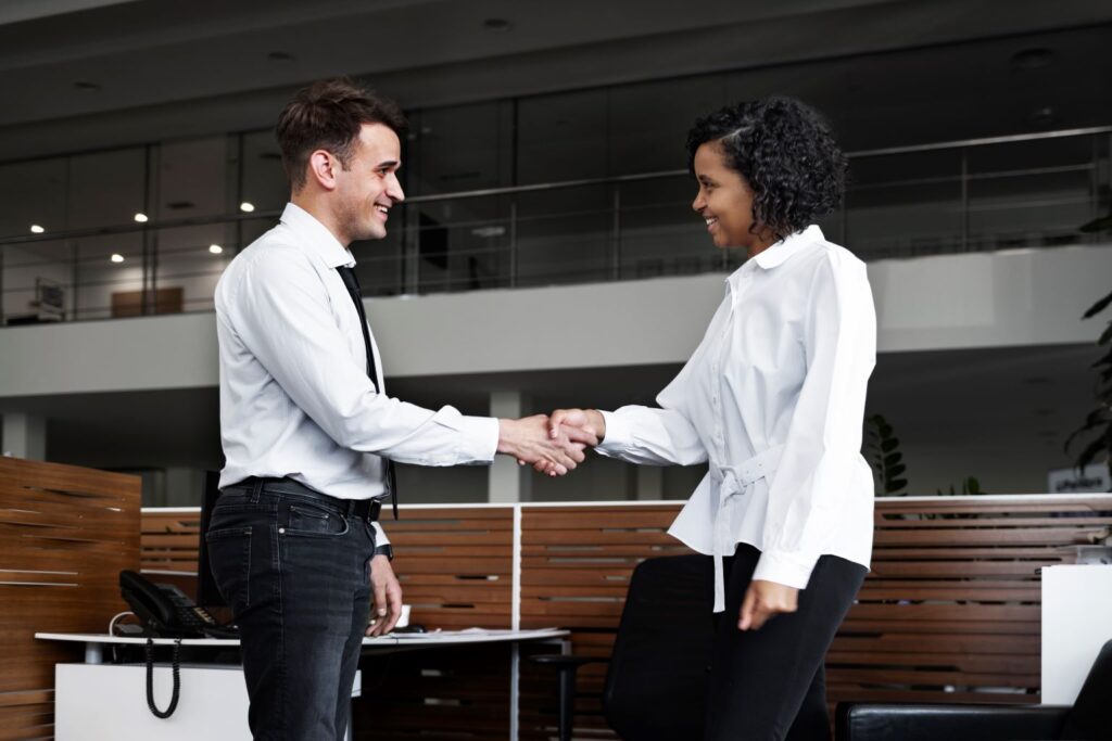 woman-shaking-a-man-as-they-come-to-business-agreement